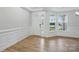 Bright entryway featuring wood-look floors, white wainscoting, a paneled door, and double-paned windows at 8716 Acadia Pkwy # 596, Sherrills Ford, NC 28673