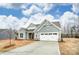 Traditional home with a two-car garage, gray siding and stone accents with long driveway at 8716 Acadia Pkwy # 596, Sherrills Ford, NC 28673