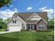 Charming home with stone and siding, a two-car garage, and a well-manicured lawn with beautiful landscaping at 8716 Acadia Pkwy # 596, Sherrills Ford, NC 28673