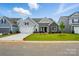Charming single-Gathering home with a well-manicured lawn, stone accents, and an attached two-car garage at 8716 Acadia Pkwy # 596, Sherrills Ford, NC 28673