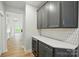 Kitchen with gray cabinetry, quartz countertops, wine cooler and stylish backsplash at 8716 Acadia Pkwy # 596, Sherrills Ford, NC 28673