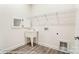 Convenient laundry room features utility sink, wire shelving and connections for laundry machines at 8716 Acadia Pkwy # 596, Sherrills Ford, NC 28673