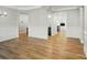 Open-concept living room with wood-look floors, white trim, and views to other rooms at 8716 Acadia Pkwy # 596, Sherrills Ford, NC 28673