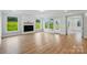 Spacious living room features a fireplace with white shiplap surround, wood flooring, and bright windows at 8716 Acadia Pkwy # 596, Sherrills Ford, NC 28673