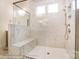 Contemporary shower with herringbone pattern, gray tile, frameless glass enclosure, and bench seating at 8716 Acadia Pkwy # 596, Sherrills Ford, NC 28673