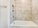 Elegant tiled shower featuring neutral tile and shower niche for storage at 8716 Acadia Pkwy # 596, Sherrills Ford, NC 28673
