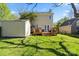 Backyard view with a wooden deck, green lawn, storage shed, and fenced area at 9108 Clifton Meadow Dr, Matthews, NC 28105