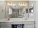 Well-lit bathroom featuring double sinks, a large mirror, and a walk-in shower with glass doors at 9108 Clifton Meadow Dr, Matthews, NC 28105