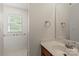 Simple bathroom with a single sink, wood cabinets, a large mirror, and a window for natural light at 9108 Clifton Meadow Dr, Matthews, NC 28105