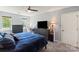 Bright bedroom with a ceiling fan, carpet floors, and two windows providing plenty of natural light at 9108 Clifton Meadow Dr, Matthews, NC 28105