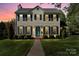 Exterior view of a well-maintained two-story house with dark shutters and a green lawn at 9108 Clifton Meadow Dr, Matthews, NC 28105