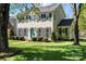 Classic two-story home with manicured lawn, symmetrical design, and a vibrant blue front door at 9108 Clifton Meadow Dr, Matthews, NC 28105