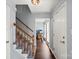 Entryway with hardwood floors, carpeted stairs, leading into a room with large windows at 9108 Clifton Meadow Dr, Matthews, NC 28105