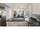 Open-concept kitchen with stainless steel appliances, granite counters, and view to living spaces at 9108 Clifton Meadow Dr, Matthews, NC 28105