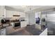 Modern kitchen boasts stainless steel appliances, dark granite countertops, and ample cabinet space at 9108 Clifton Meadow Dr, Matthews, NC 28105