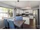 Well-lit kitchen featuring stainless steel appliances, granite countertops, and an adjacent dining area at 9108 Clifton Meadow Dr, Matthews, NC 28105