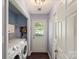 Bright laundry room with a white washer and dryer and hooks for organizing clothes at 9108 Clifton Meadow Dr, Matthews, NC 28105
