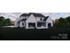Expansive backyard featuring a brick-clad two-story home with a covered patio, and lush landscaping at 1017 Broadmoor Dr # 60, Marvin, NC 28173