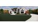 Stunning two-story home with a white brick exterior, black trim windows, manicured lawn, and ample curb appeal at 1017 Broadmoor Dr # 60, Marvin, NC 28173