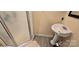 Bathroom with tiled floor, white pedestal sink, and glass door shower at 1024 Old Mountain View Rd, Mount Holly, NC 28120