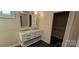 Bright bathroom featuring a double vanity with undermount sinks and a large mirror at 1024 Old Mountain View Rd, Mount Holly, NC 28120