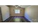 Spacious bedroom with wood flooring, a ceiling fan, and a window providing natural light at 1024 Old Mountain View Rd, Mount Holly, NC 28120
