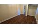 Bedroom with neutral walls, wood floors, view into a closet, and electrical outlets at 1024 Old Mountain View Rd, Mount Holly, NC 28120