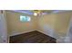 A bright bedroom with wood-look floors, a ceiling fan, and natural light from the window at 1024 Old Mountain View Rd, Mount Holly, NC 28120