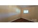 Bedroom with neutral walls, wood floors, a window, and electrical outlets at 1024 Old Mountain View Rd, Mount Holly, NC 28120