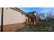 Side view of the home, highlighting a covered back porch and brick foundation at 1024 Old Mountain View Rd, Mount Holly, NC 28120