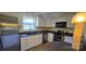Well-lit kitchen with stainless steel appliances, modern lighting, and ample countertop space at 1024 Old Mountain View Rd, Mount Holly, NC 28120