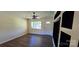 Bright living room with modern ceiling fan, an open door, and a sleek, built-in feature wall at 1024 Old Mountain View Rd, Mount Holly, NC 28120