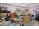 Cluttered basement with dresser, bed, storage containers, and personal items at 10700 Summitt Tree Ct, Charlotte, NC 28277
