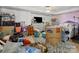 Cluttered basement with dresser, bed, storage containers, and personal items at 10700 Summitt Tree Ct, Charlotte, NC 28277