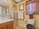 Cozy bathroom with a wood vanity, shower, and patterned curtains at 10700 Summitt Tree Ct, Charlotte, NC 28277