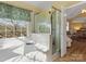 Bright bathroom with bathtub, shower, and window offering a relaxing view at 10700 Summitt Tree Ct, Charlotte, NC 28277
