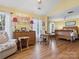 Well-lit bedroom with wood floors, a desk, and a comfortable chair at 10700 Summitt Tree Ct, Charlotte, NC 28277