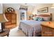 Cozy bedroom with patterned bedding, wood furniture, and a bright window at 10700 Summitt Tree Ct, Charlotte, NC 28277