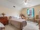 Bright bedroom with neutral tones, a desk, and a soft, inviting bed at 10700 Summitt Tree Ct, Charlotte, NC 28277
