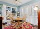 Bright dining area with wood table, four chairs, lots of light and a floral rug at 10700 Summitt Tree Ct, Charlotte, NC 28277