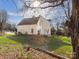 View of the exterior of the house with a lawn, trees and a deck on a sunny day at 10700 Summitt Tree Ct, Charlotte, NC 28277
