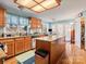 Spacious kitchen with an island, wood cabinets, stainless steel appliances, and hardwood floors at 10700 Summitt Tree Ct, Charlotte, NC 28277