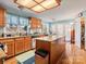 Spacious kitchen with an island, wood cabinets, stainless steel appliances, and hardwood floors at 10700 Summitt Tree Ct, Charlotte, NC 28277