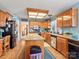 Spacious kitchen with wood cabinets, granite countertops, stainless steel appliances, and wood flooring at 10700 Summitt Tree Ct, Charlotte, NC 28277