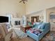 Bright, airy living room features vaulted ceilings, a cozy fireplace, and stylish furnishings at 10700 Summitt Tree Ct, Charlotte, NC 28277