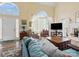 Bright living room features vaulted ceilings and large windows, creating a warm and inviting atmosphere at 10700 Summitt Tree Ct, Charlotte, NC 28277