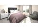 Bedroom with a dark gray upholstered headboard, a nightstand and large window with sunlight at 1105 Harry Ct, Albemarle, NC 28001