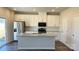 Modern kitchen with white cabinets, stainless steel appliances, and a granite-top island at 1105 Harry Ct, Albemarle, NC 28001