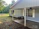 Cozy back porch features a swing and ceiling fan at 13080 Philadelphia Church Rd, Oakboro, NC 28129