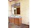 Bathroom featuring a double sink vanity and a large mirror with vintage floral wallpaper at 13080 Philadelphia Church Rd, Oakboro, NC 28129